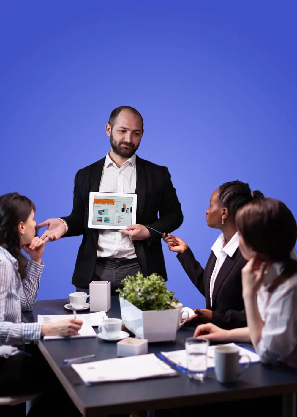 A Bumppd strategist presenting ideas on a tablet to a team A Bumppd strategist presenting ideas on a tablet to a team